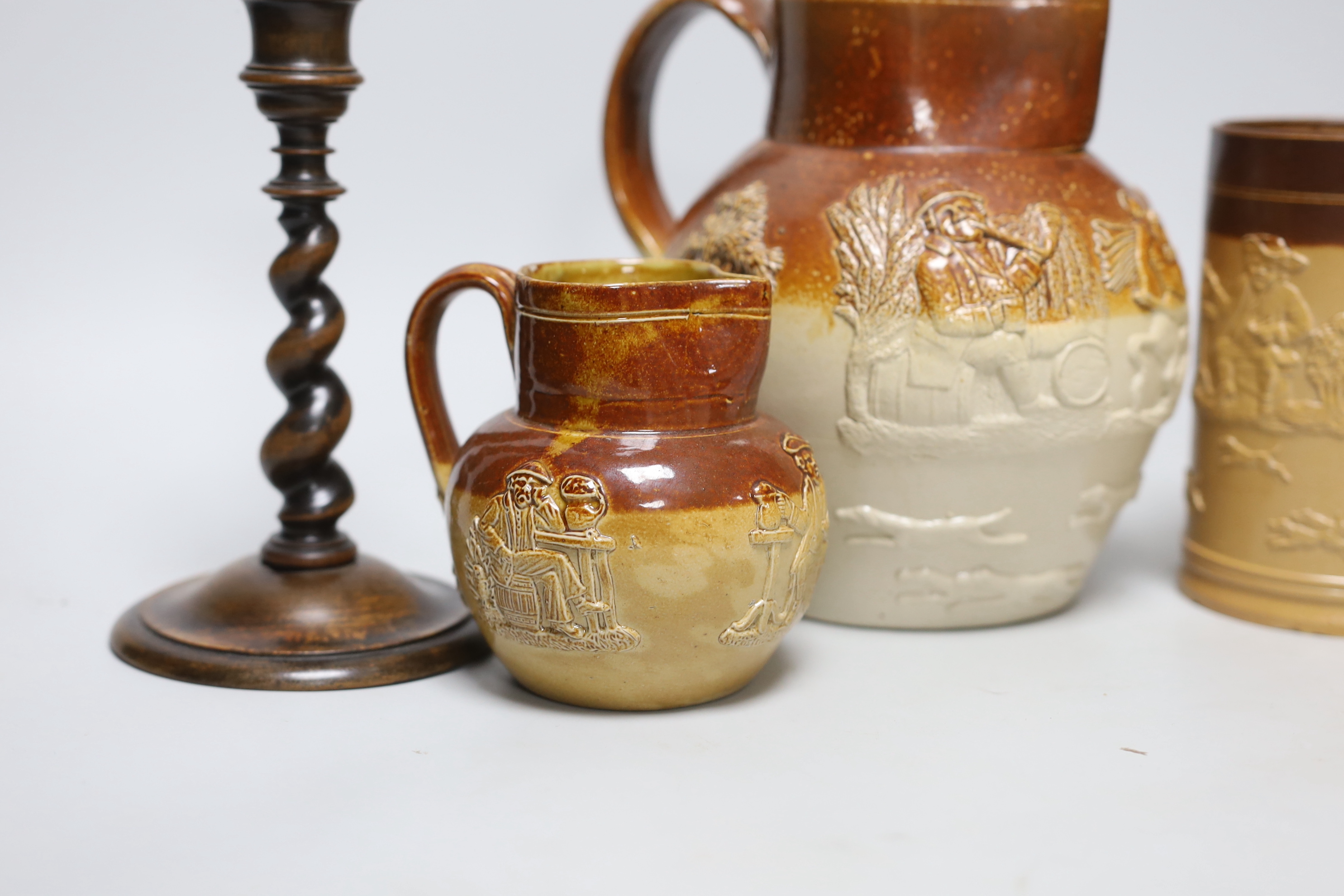 A group of three salt-glazed stoneware vessels and a pair of walnut barley-twist candlesticks, the largest 19cm high